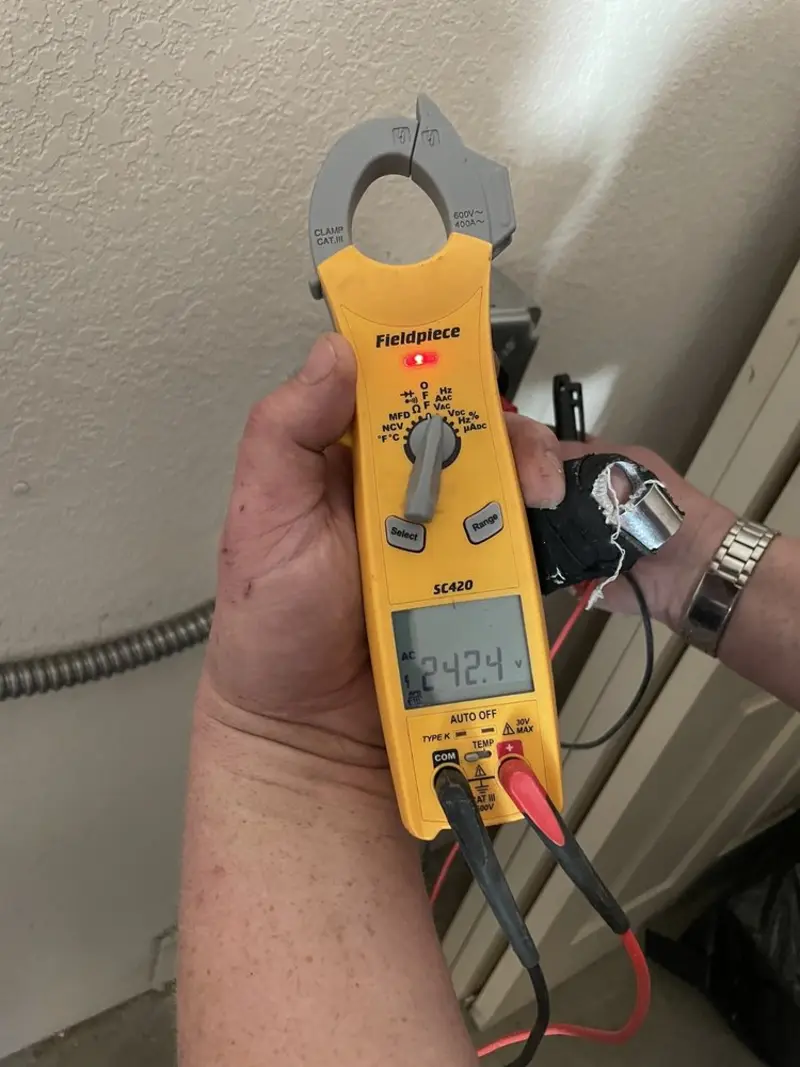 Voltage testing with clamp meter during Outlet Installation in Andover